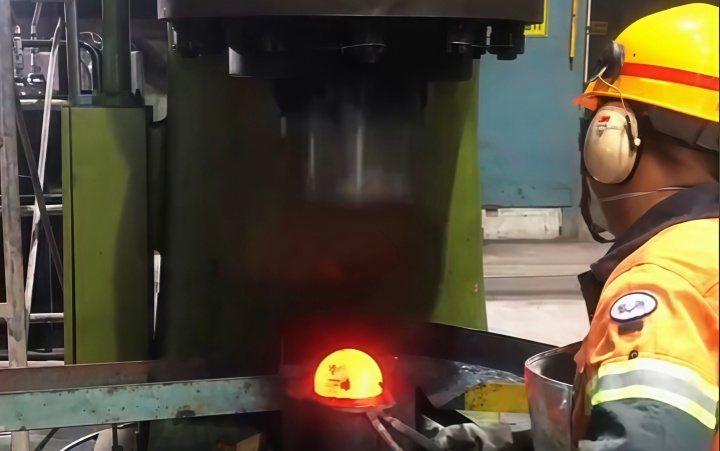 Forging steel balls with a pneumatic hammer.